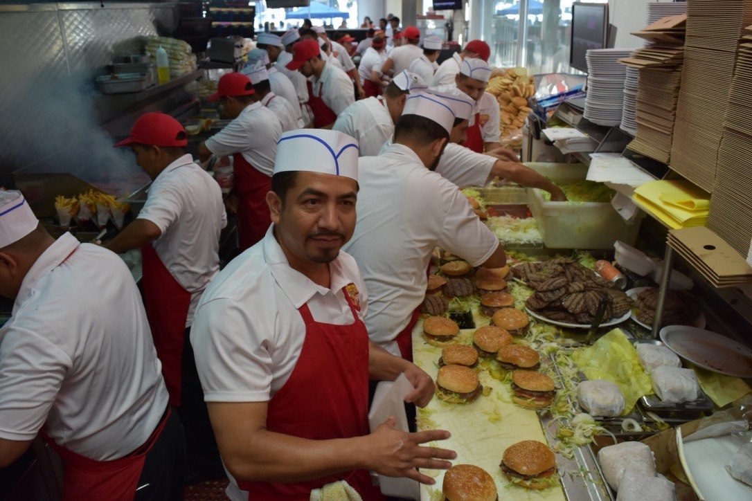 Tom's Jr. Burgers kitchen team preparing fresh burgers